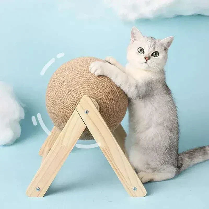 Cat playing with a sisal rope ball scratching toy on a wooden stand for indoor use.