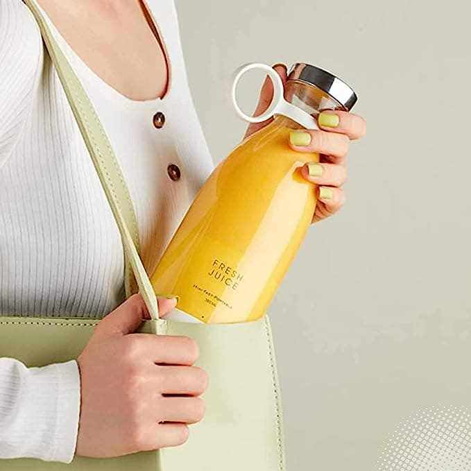 Portable Blender with four blades for smoothies, showcased in use, highlighting its compact, wireless, and food-grade features.