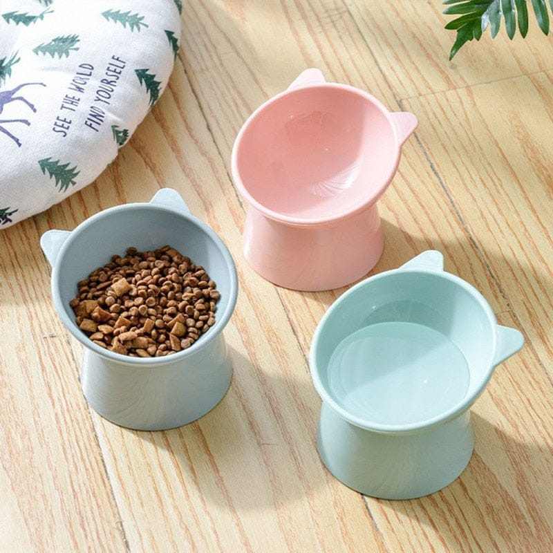 Elevated pet food and water bowls with ergonomic design for cats and dogs.