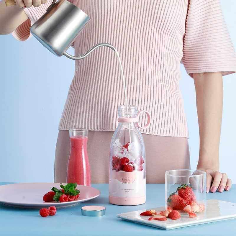 Portable blender with fruit, perfect for smoothies, easy to clean and recharge.