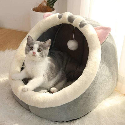 Animal shape cat bed with plush lining and cat inside.