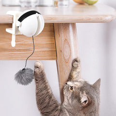 Electric Motion Cat Toy clipped to table with cat playing.